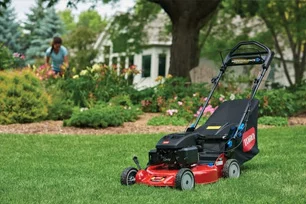 Toro Mower Sitting In Mowed Grass Yard.