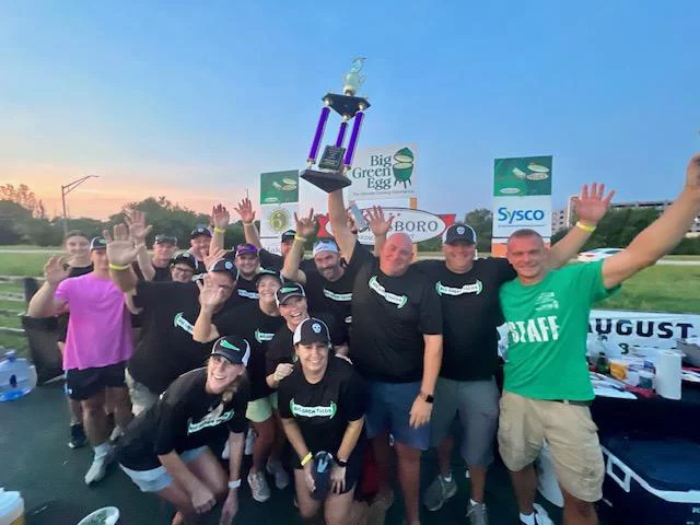 Group of cooks with trophy for people's choice