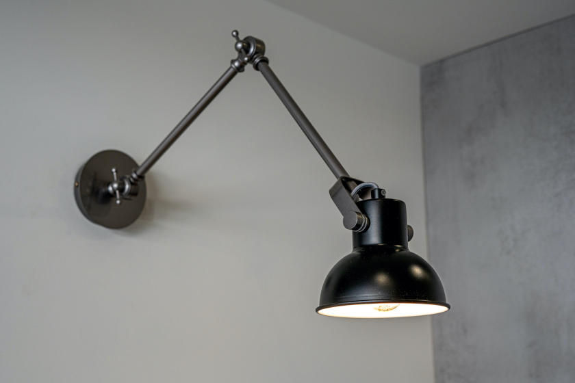Black, wall-mounted task light